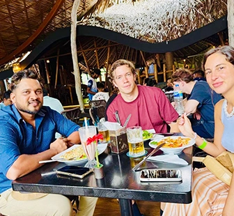 Nishan sharing a meal with travellers