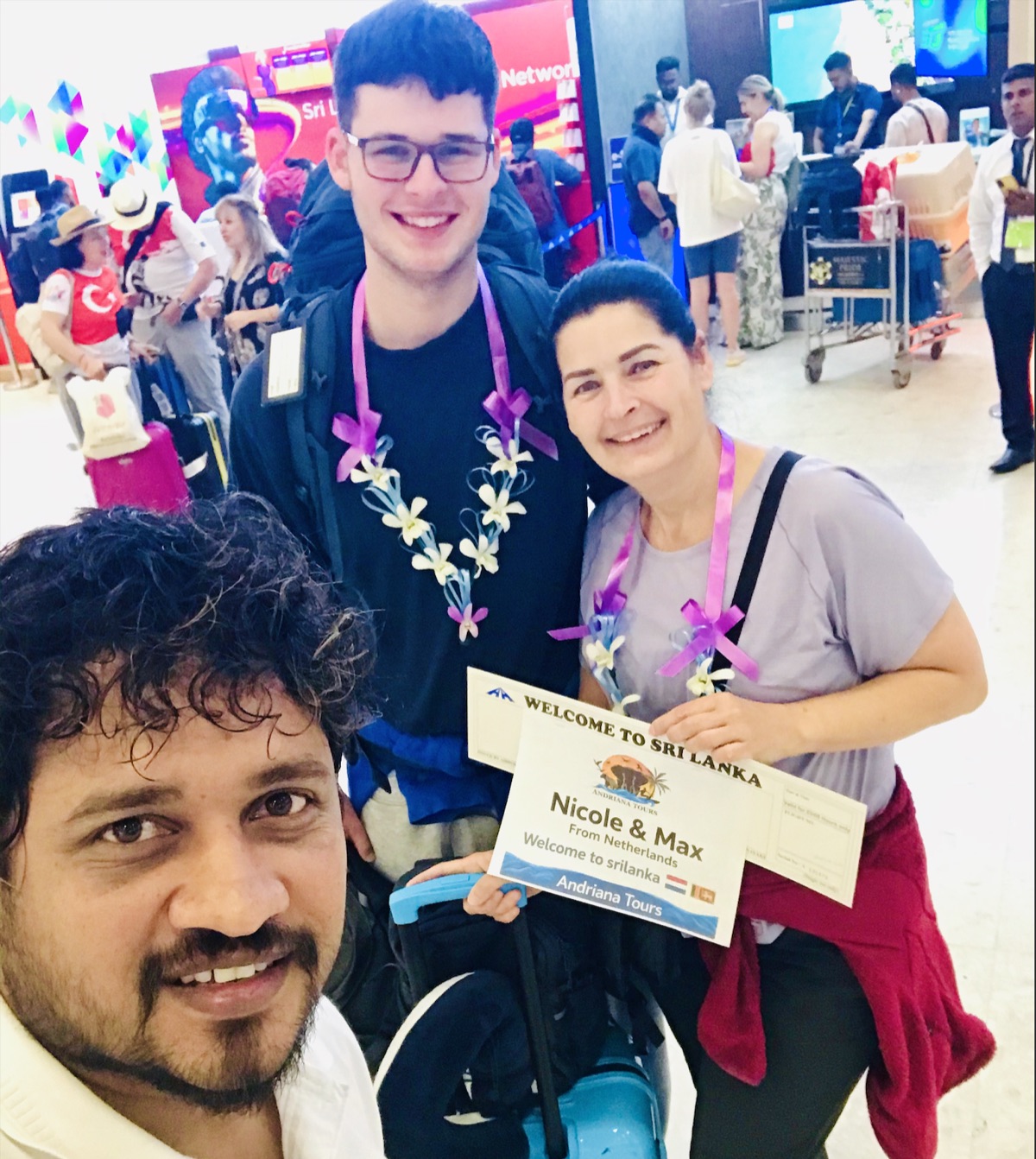 Nishan welcoming two travellers at the airport