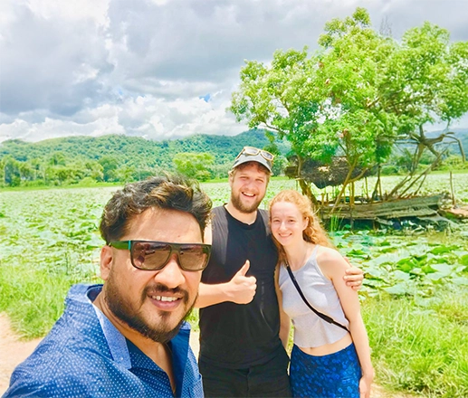 Nishan and travellers beside a lotus wetland