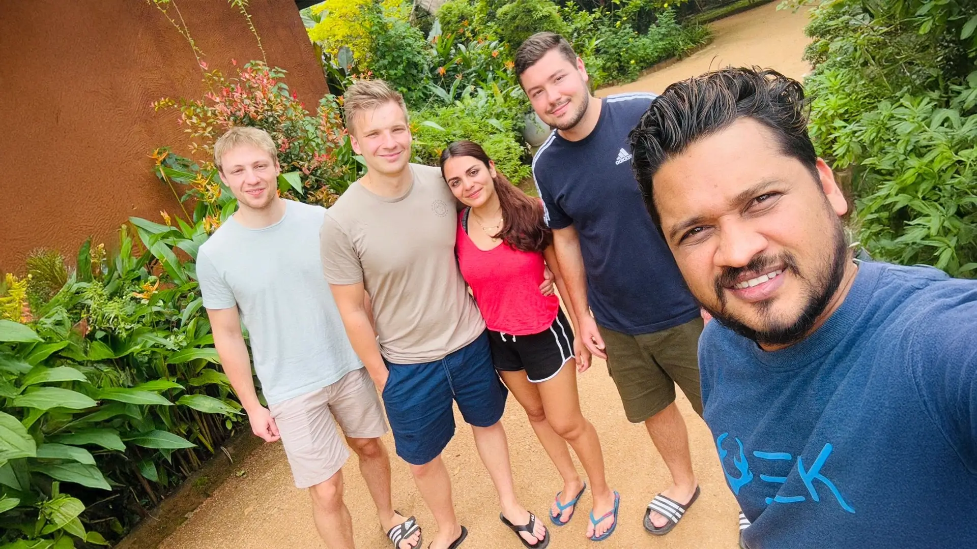 Nishan taking a group selfie with travellers